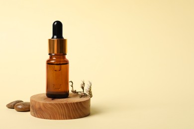 Composition with bottle of cosmetic serum on beige background. Space for text