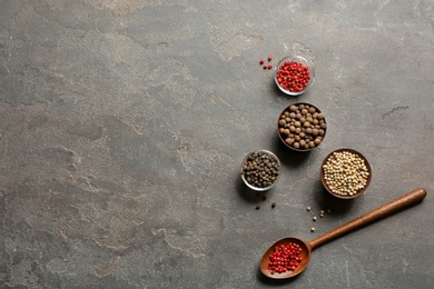 Photo of Flat lay composition with different types of pepper and space for text on gray background