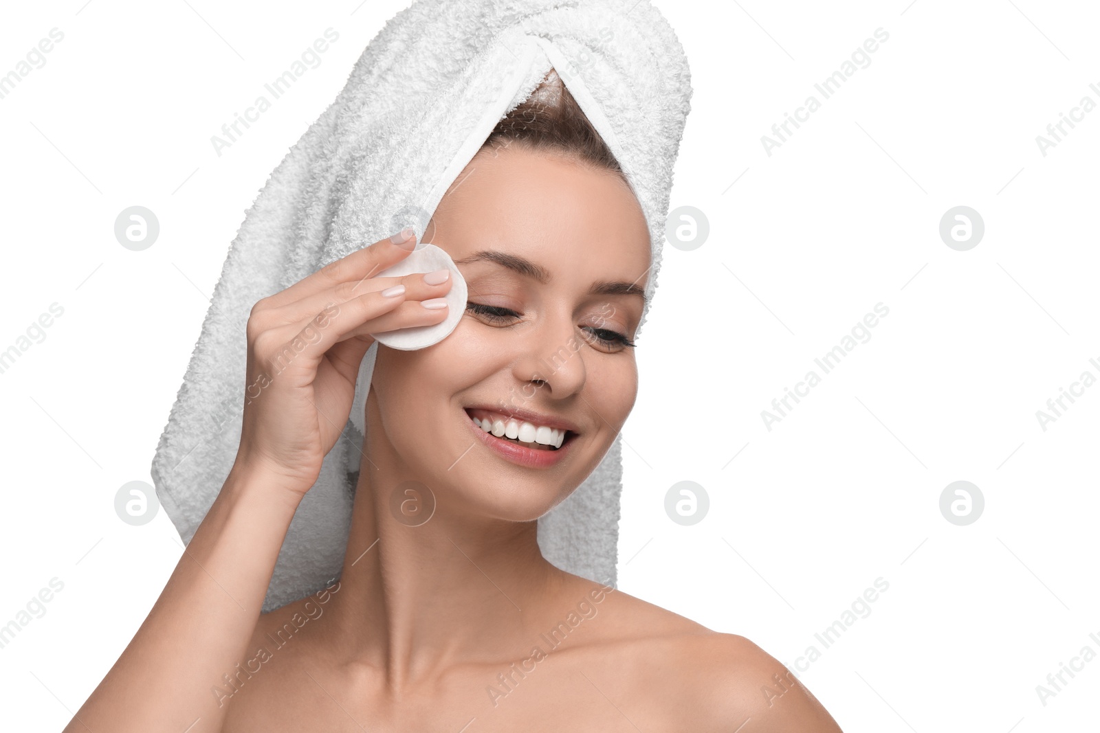 Photo of Smiling woman removing makeup with cotton pad on white background