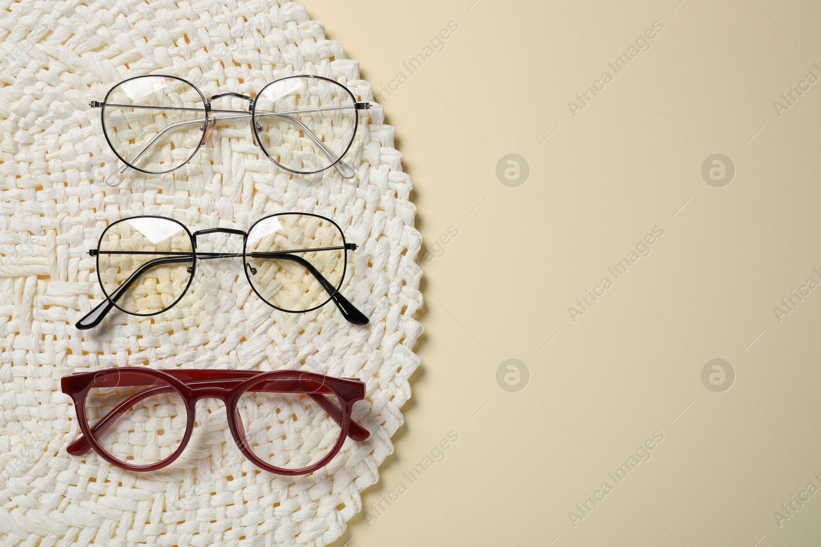 Photo of Different stylish glasses on beige background, top view. Space for text