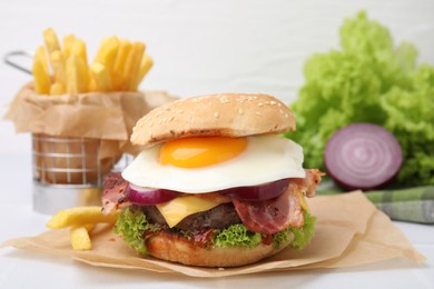 Photo of Delicious burger with fried egg on white table