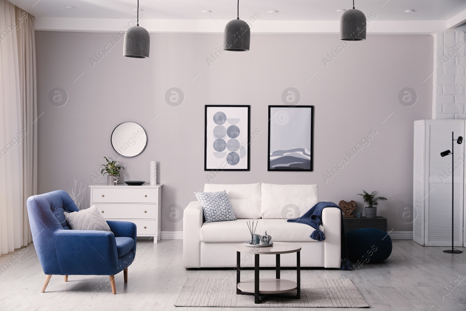 Photo of Stylish living room interior with white sofa, armchair and small coffee table