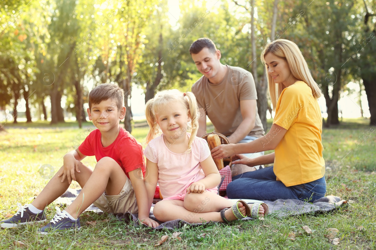 Photo of Happy family having picnic in park on sunny day