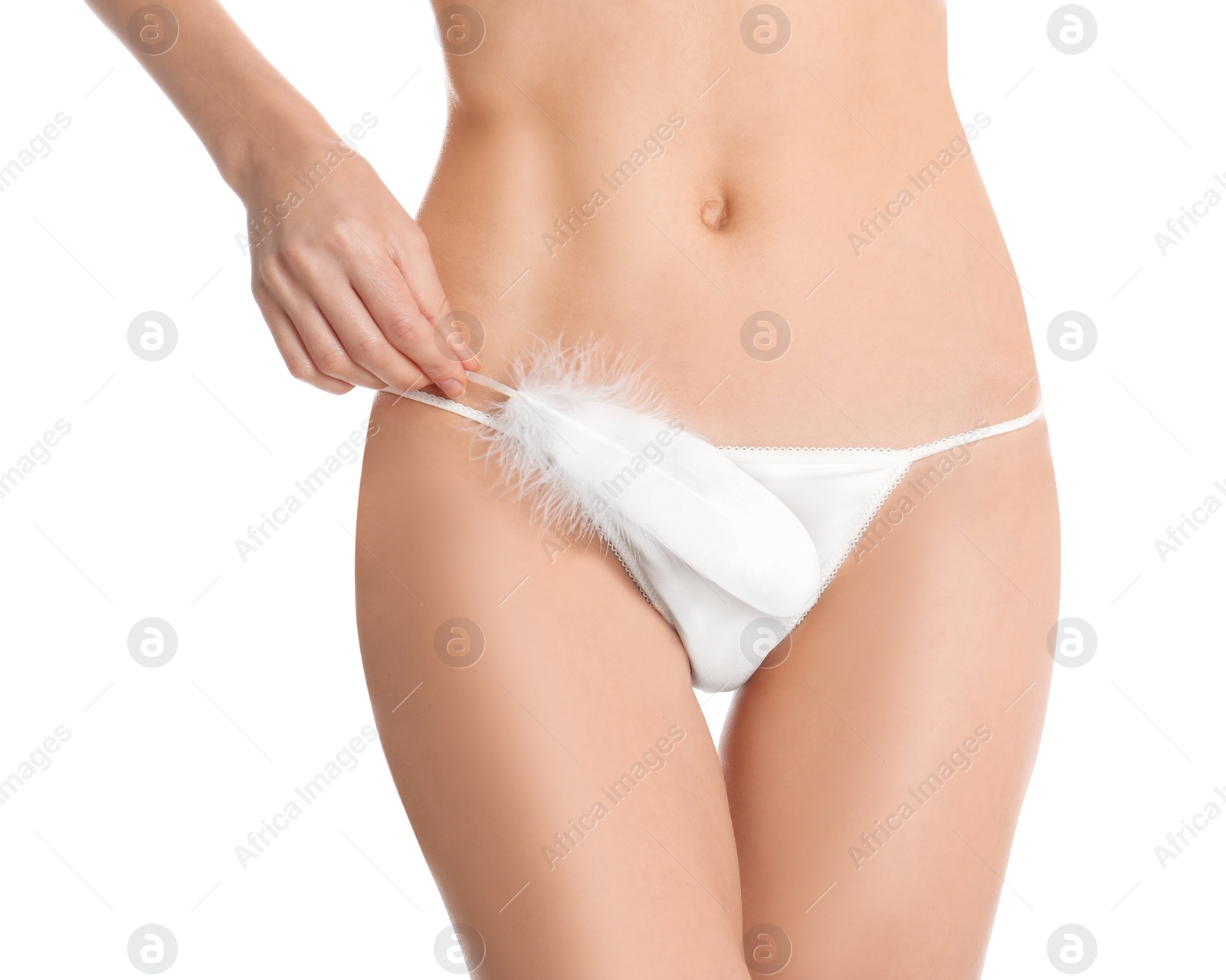 Photo of Woman with feather showing smooth skin after Brazilian bikini epilation on white background, closeup. Body care concept