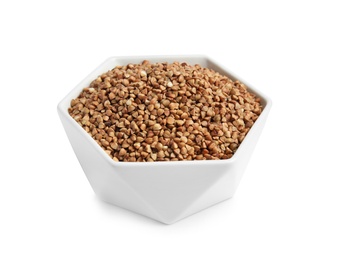 Bowl with uncooked buckwheat on white background