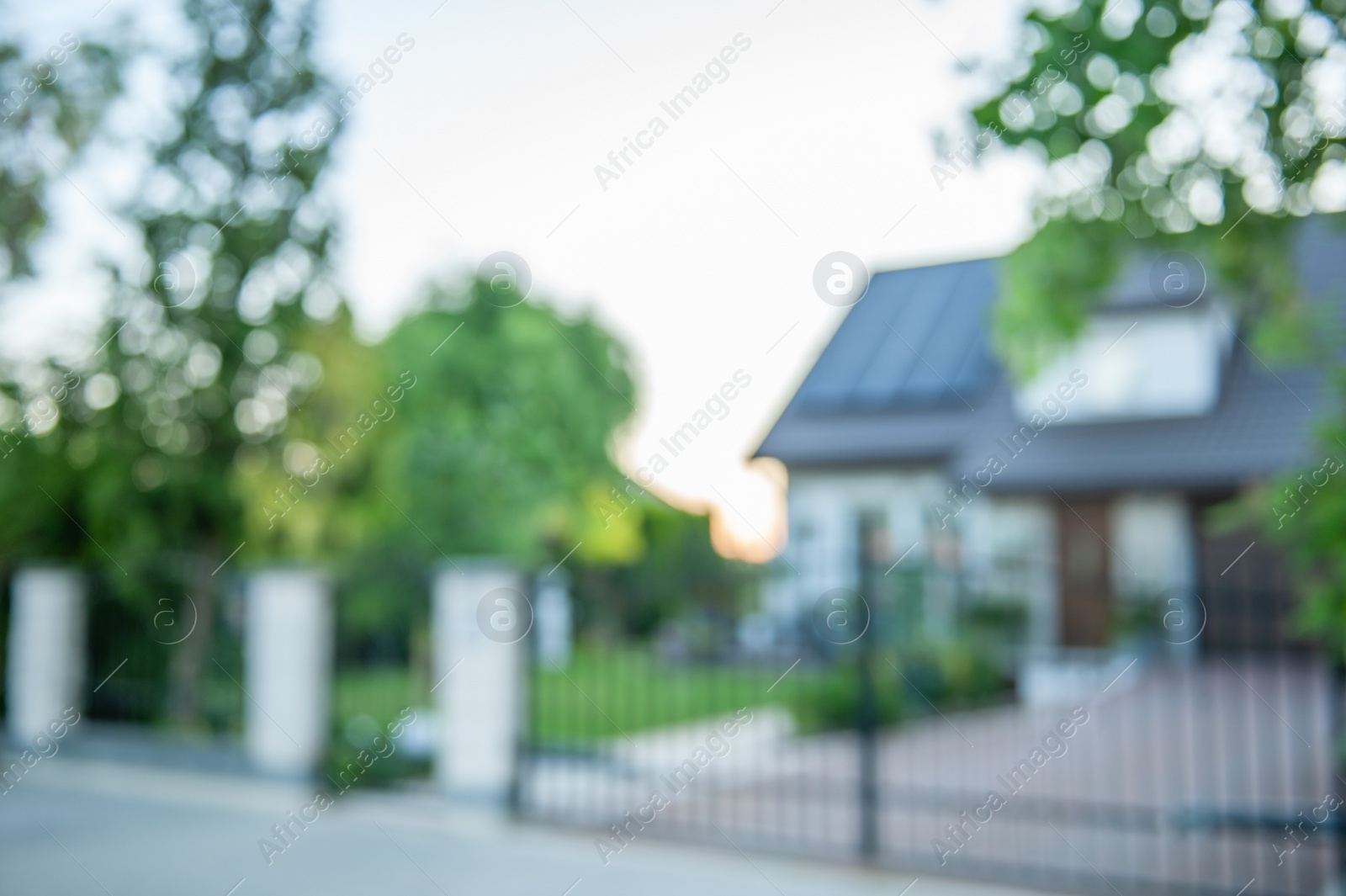 Photo of Blurred view of beautiful house behind fence