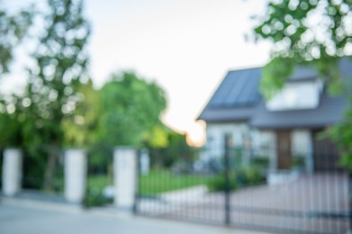 Blurred view of beautiful house behind fence