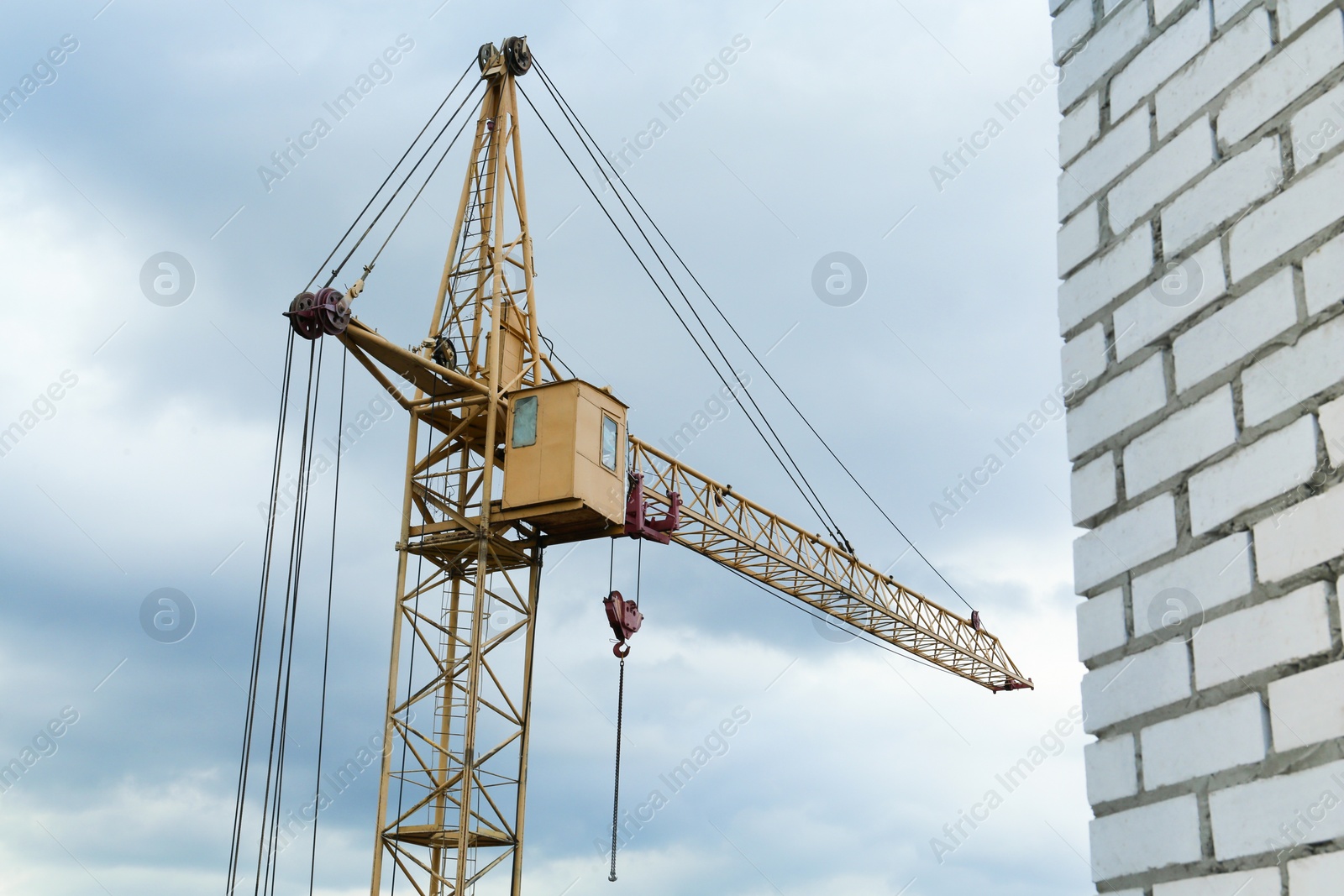 Photo of Construction site with tower crane under beautiful cloudy sky