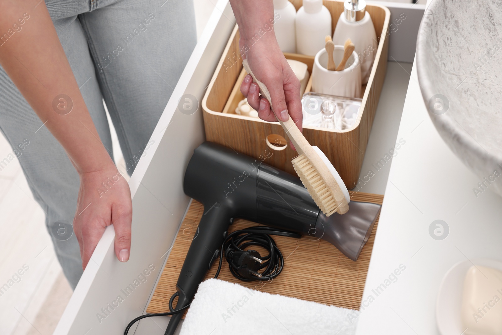 Photo of Bath accessories. Woman organizing personal care products indoors, closeup