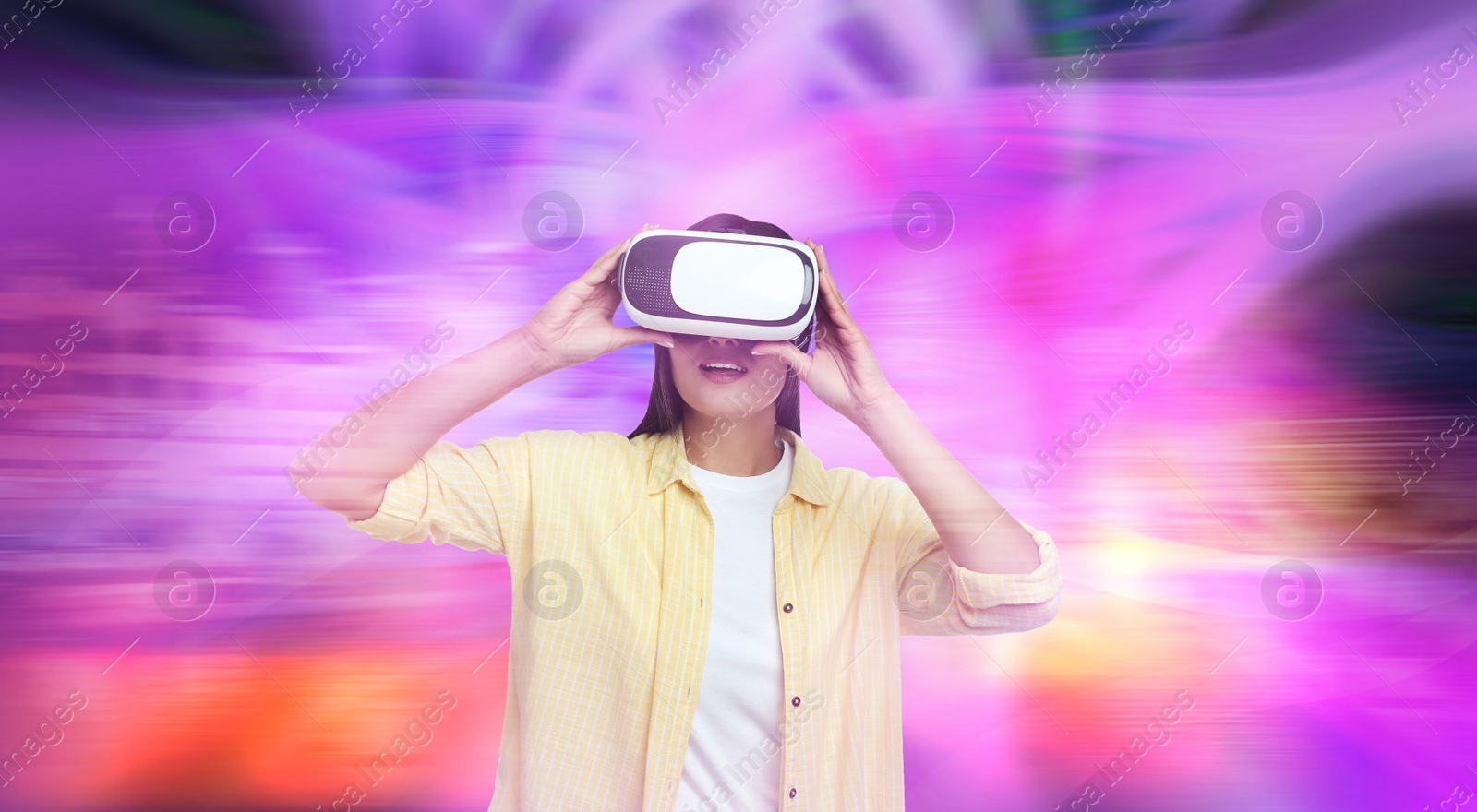 Image of Woman using virtual reality headset and getting in simulated futuristic world 