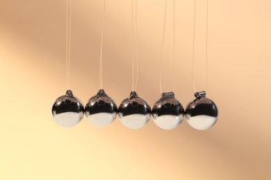Photo of Newton's cradle on color background. Physics law of energy conservation