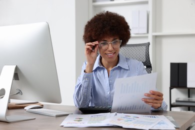 Photo of Professional accountant working at wooden desk in office