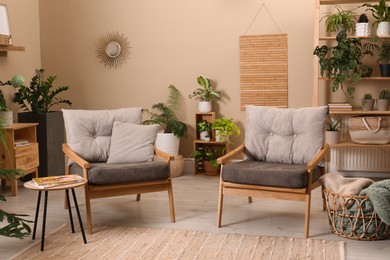 Lounge area interior with comfortable armchairs and beautiful houseplants