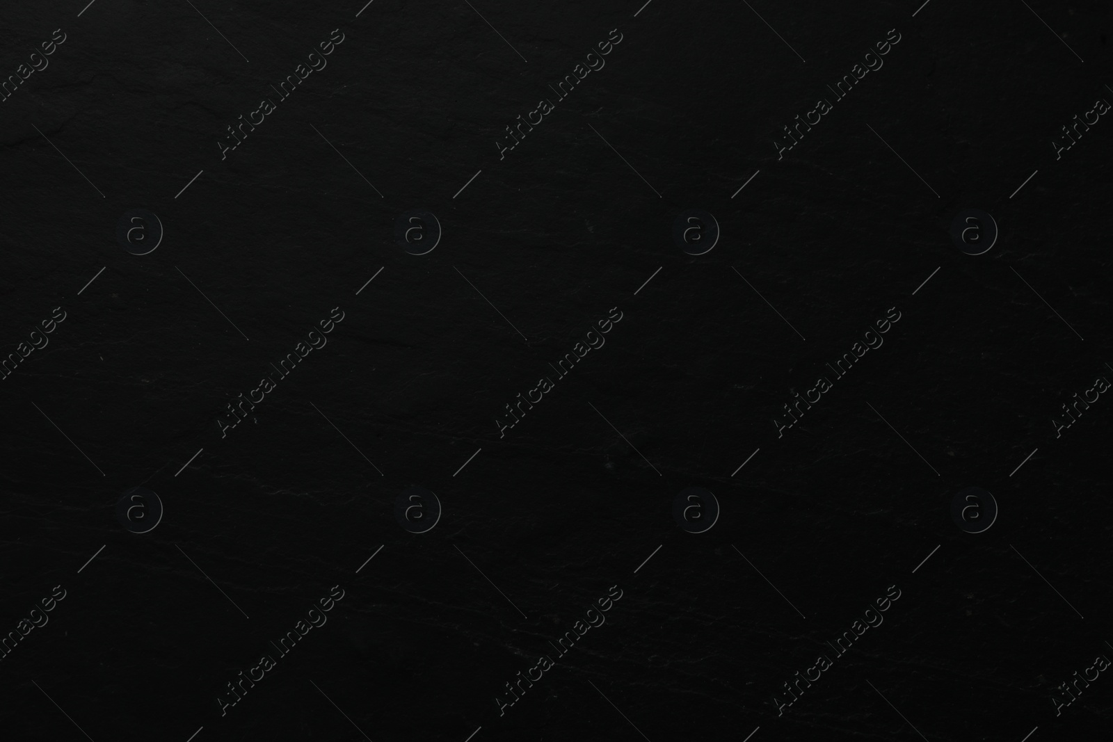 Photo of Texture of black stone surface as background, closeup