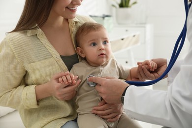 Mother with her cute baby visiting pediatrician in clinic