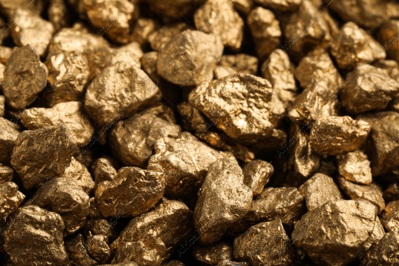 Photo of Pile of gold nuggets as background, closeup