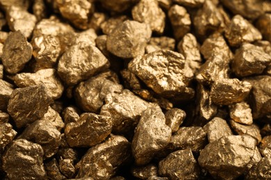 Pile of gold nuggets as background, closeup