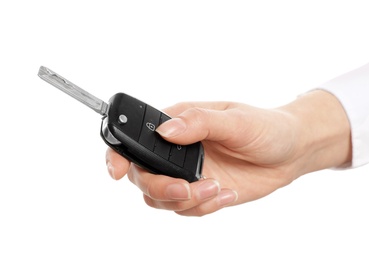 Woman holding car key isolated on white