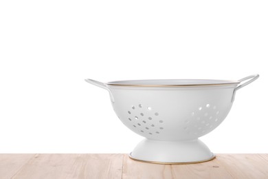 Photo of One empty colander on wooden table against white background. Space for text