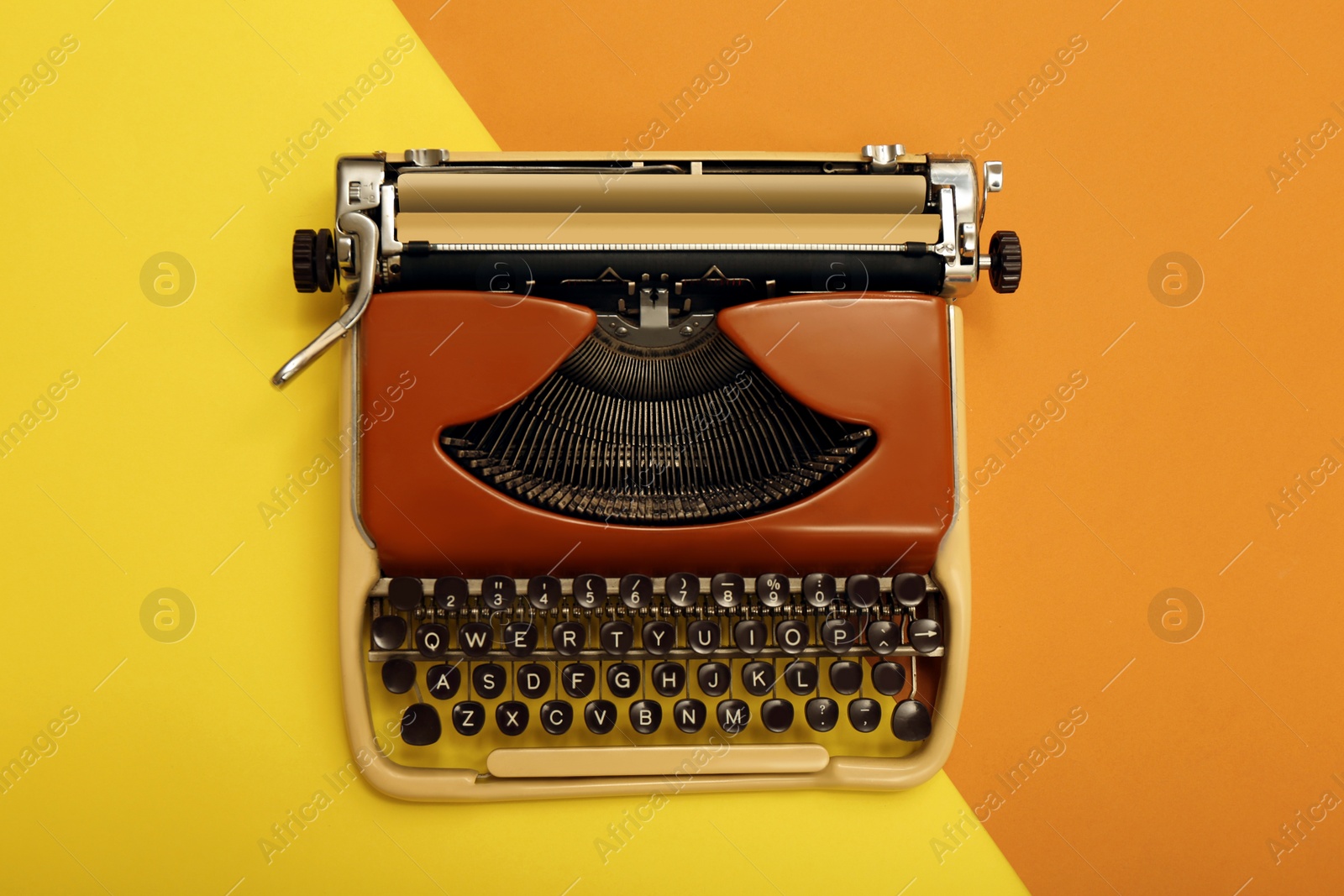 Photo of Vintage typewriter on color background, top view