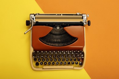 Photo of Vintage typewriter on color background, top view