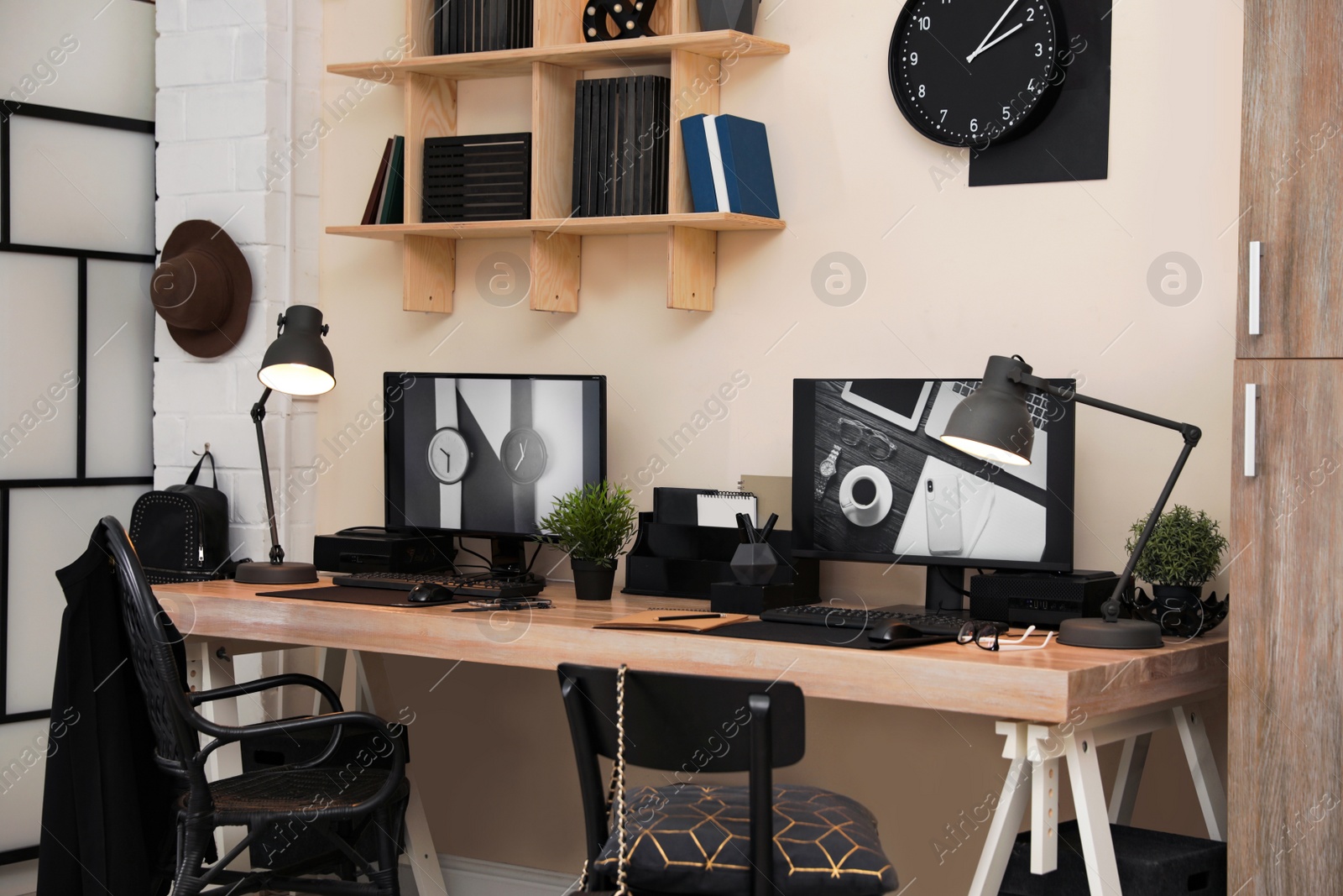 Photo of Stylish workplace interior with computers on table