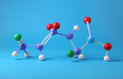 Photo of Structure of molecule on light blue background. Chemical model
