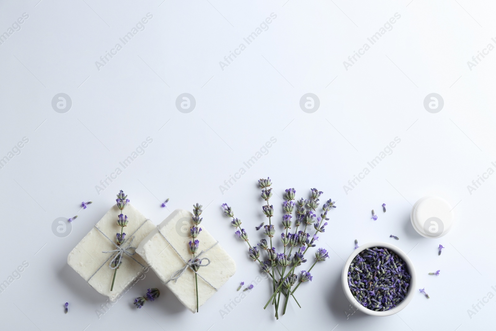 Photo of Composition with hand made soap bars and lavender flowers on white background, top view