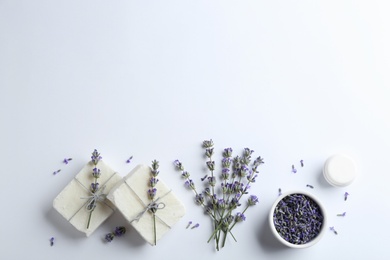 Composition with hand made soap bars and lavender flowers on white background, top view