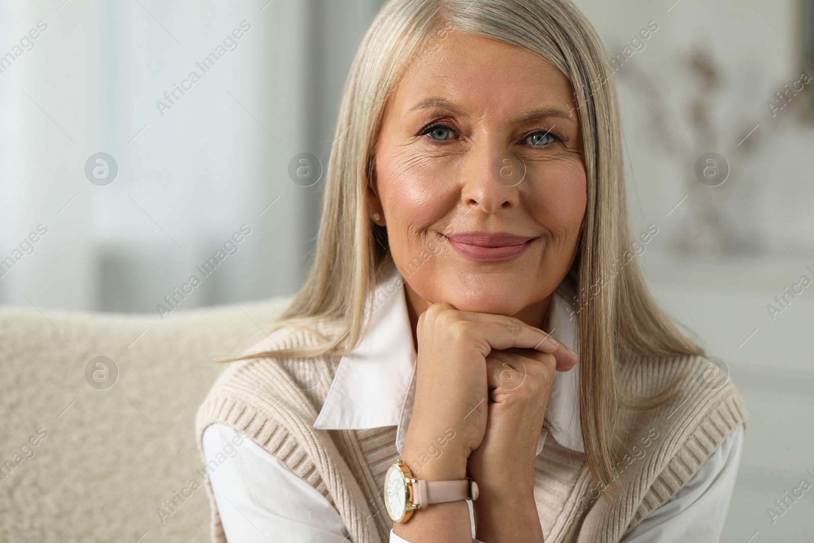 Photo of Portrait of beautiful middle aged woman at home, space for text