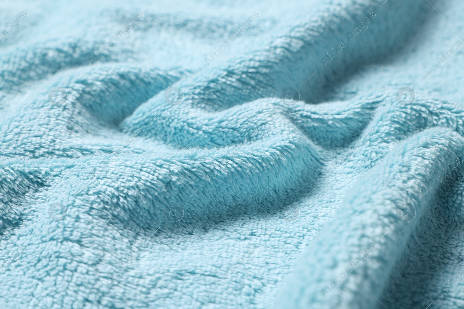 Photo of Texture of soft light blue crumpled fabric as background, closeup