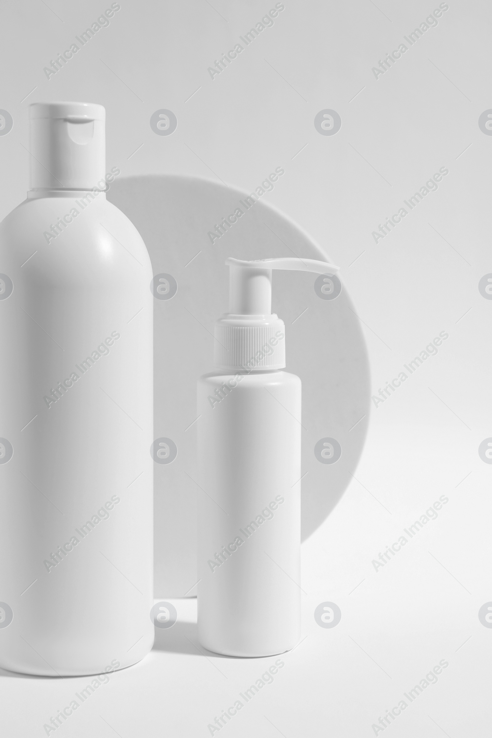 Photo of Bottles with cosmetic products on white background