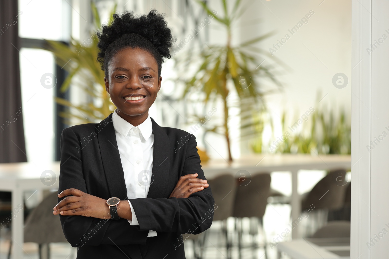 Photo of Happy woman with crossed arms in office, space for text. Lawyer, businesswoman, accountant or manager