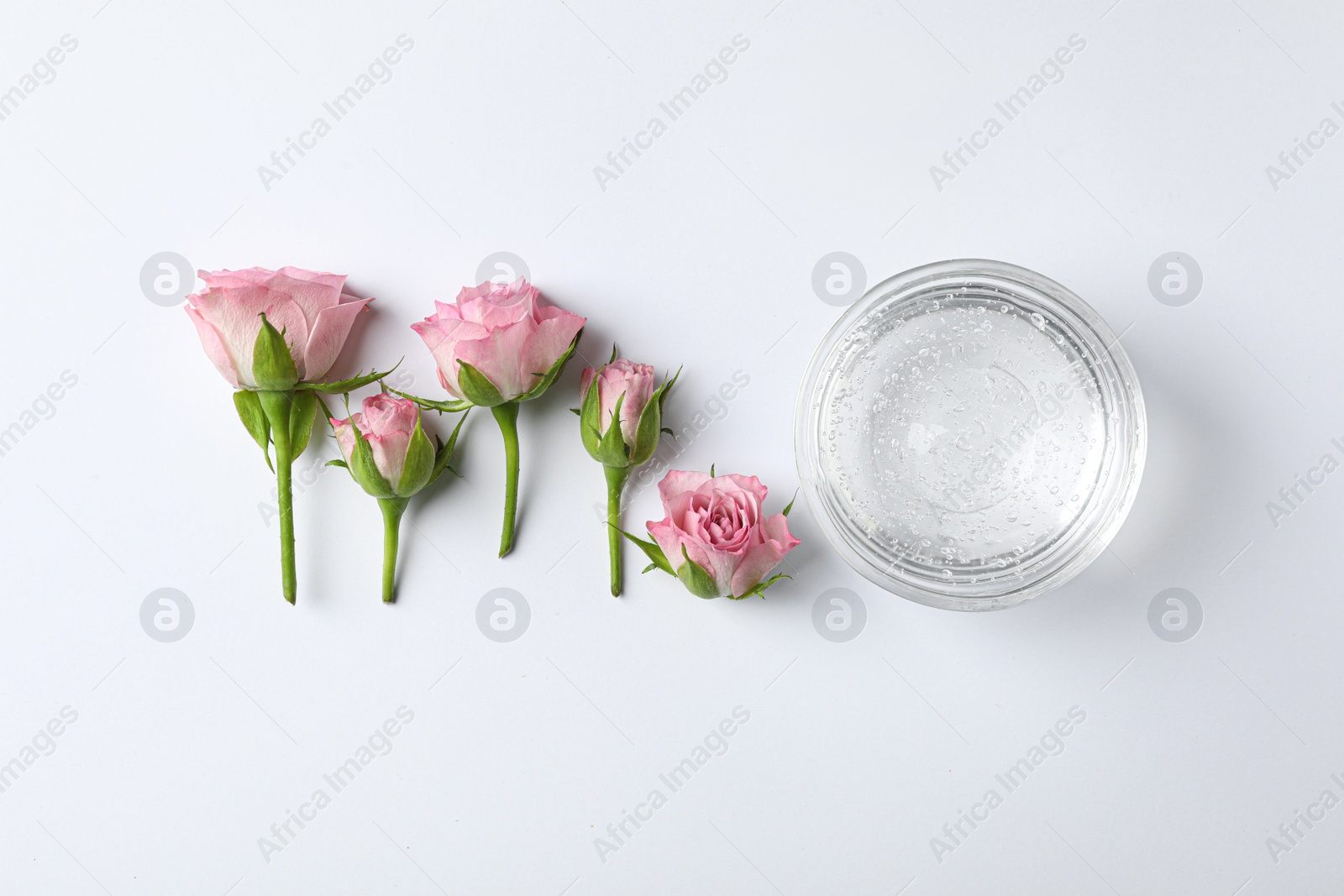 Photo of Composition with cosmetic gel and beautiful flowers on white background, top view