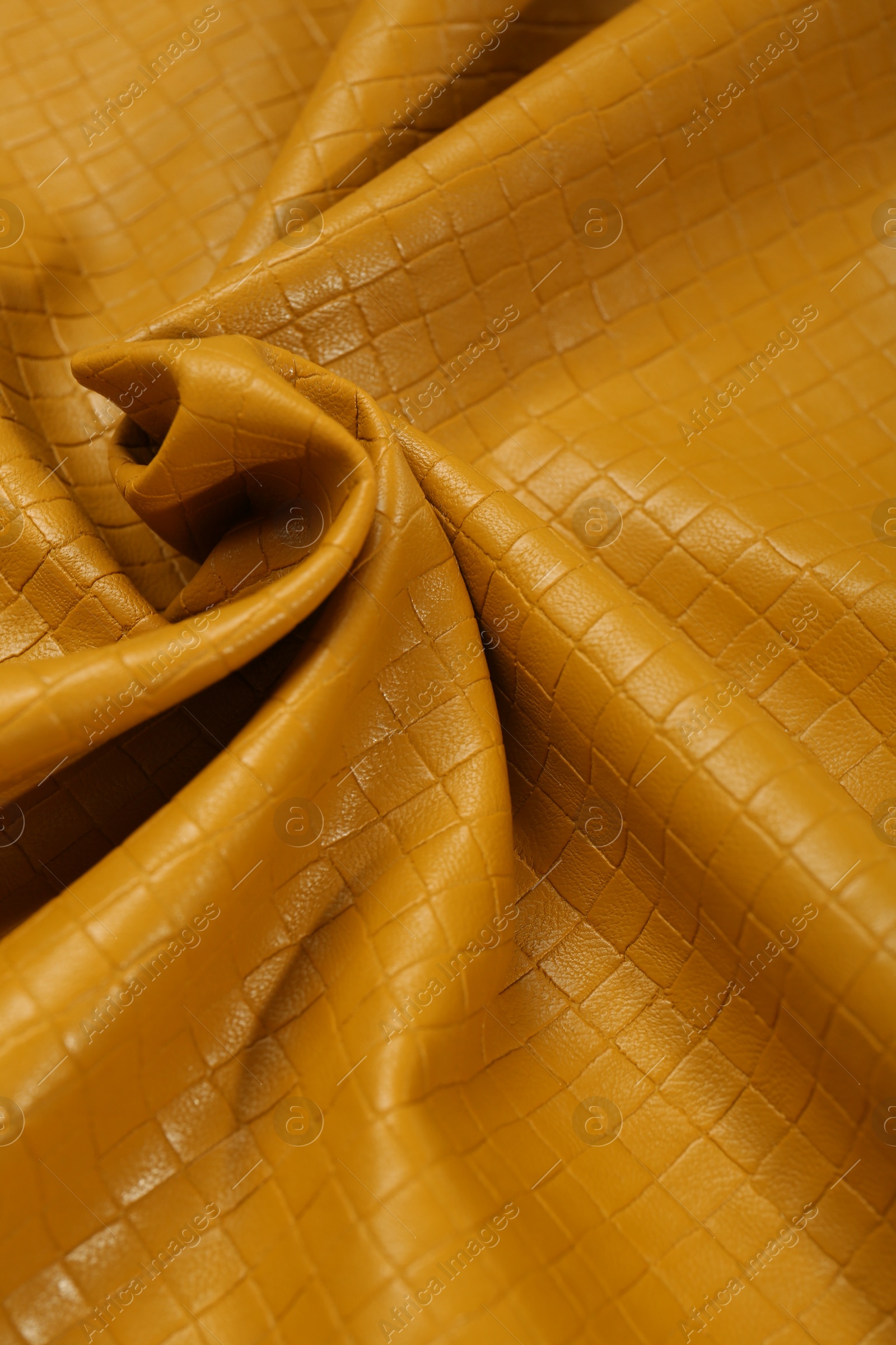 Photo of Beautiful yellow leather as background, closeup view