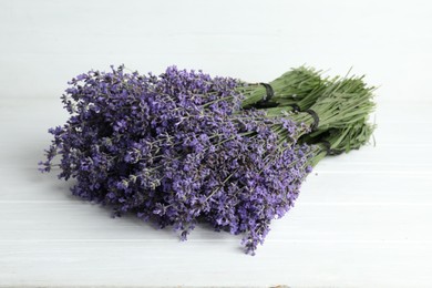 Beautiful lavender bouquets on white wooden table