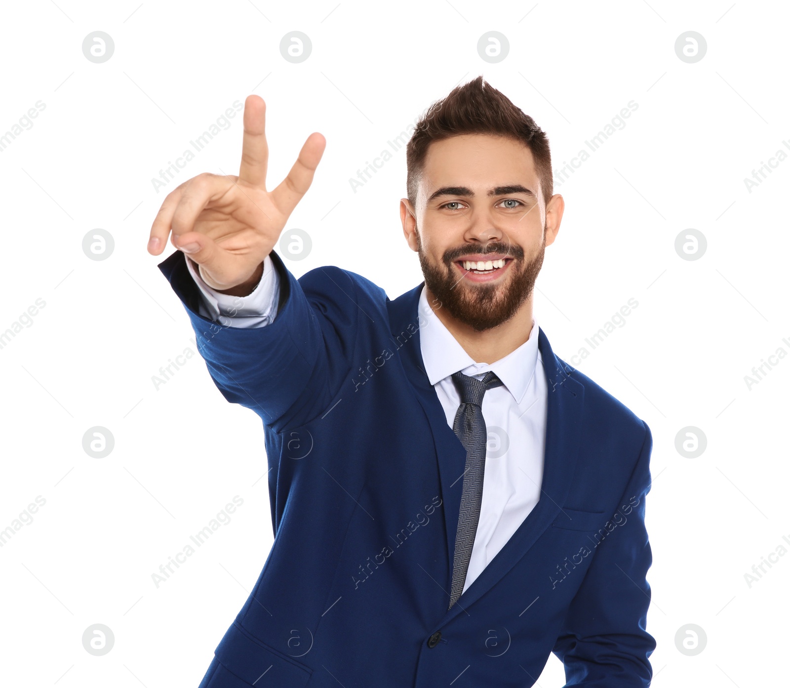 Photo of Happy young businessman showing victory gesture on white background