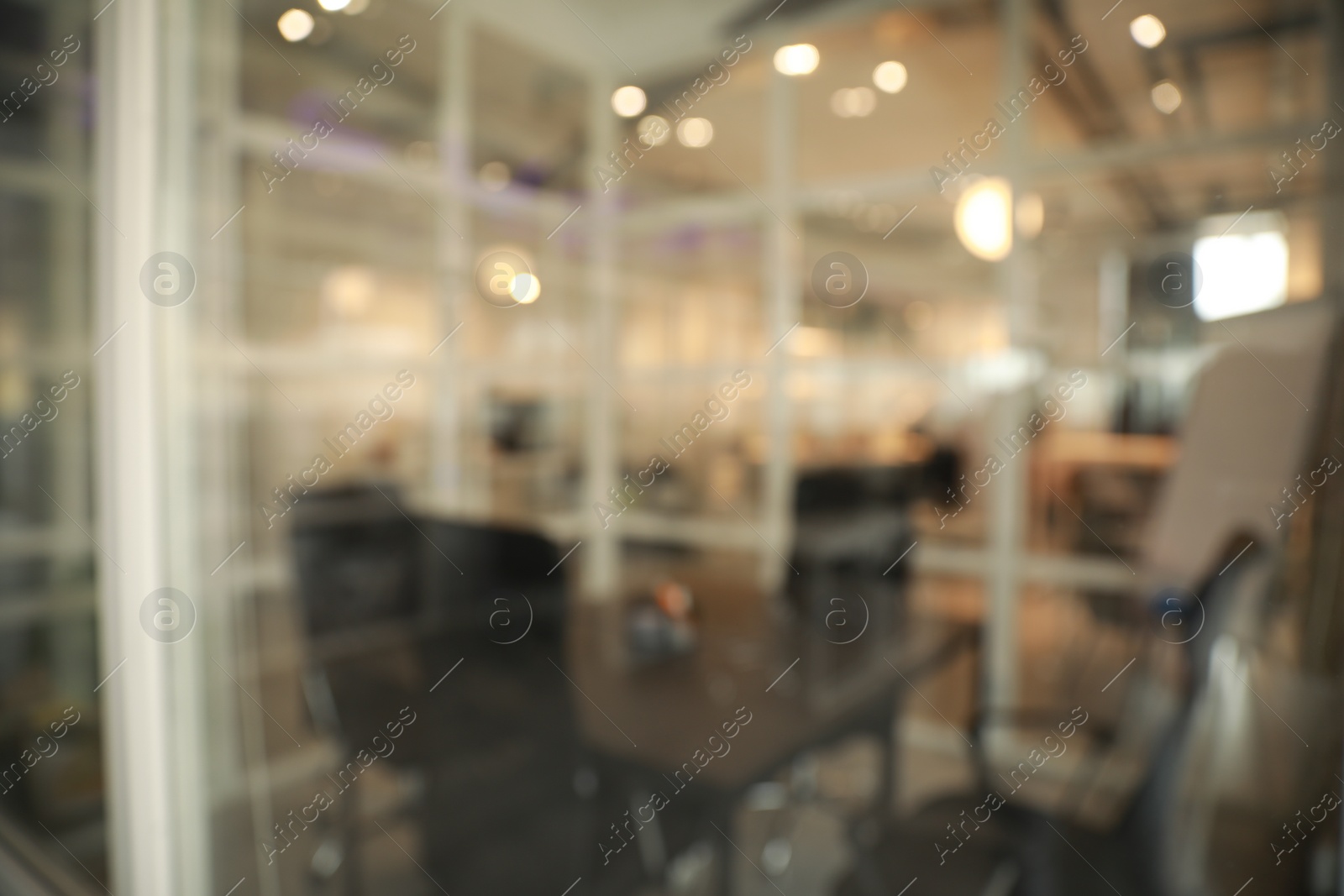 Photo of Blurred view of cozy workplace zone with table and chairs in office