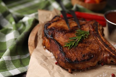 Photo of Tasty marinated meat, rosemary and spices on table, closeup