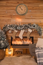 Festive room interior with decorative fireplace and Christmas stockings