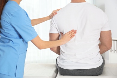 Photo of Doctor working with patient in hospital, closeup. Rehabilitation massage