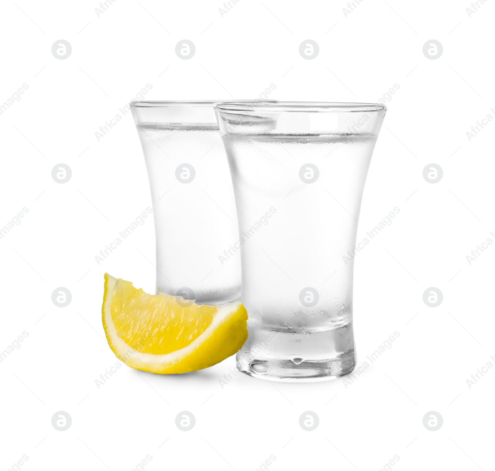 Photo of Shot glasses of vodka with lemon slice on white background