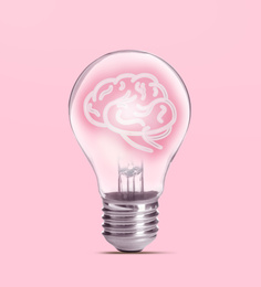 Lamp bulb with human brain inside on pink background. Idea generation