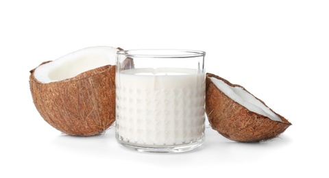 Glass with coconut milk on white background