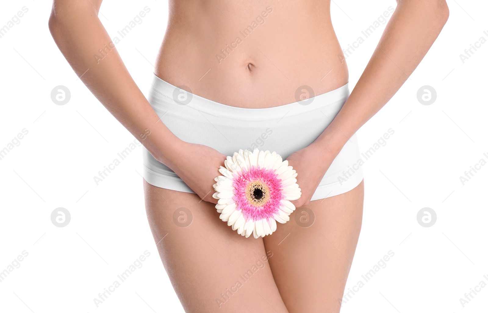 Photo of Young woman holding flower near underwear on white background. Gynecology