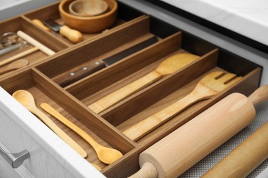 Photo of Open drawerkitchen cabinet with different utensils, closeup