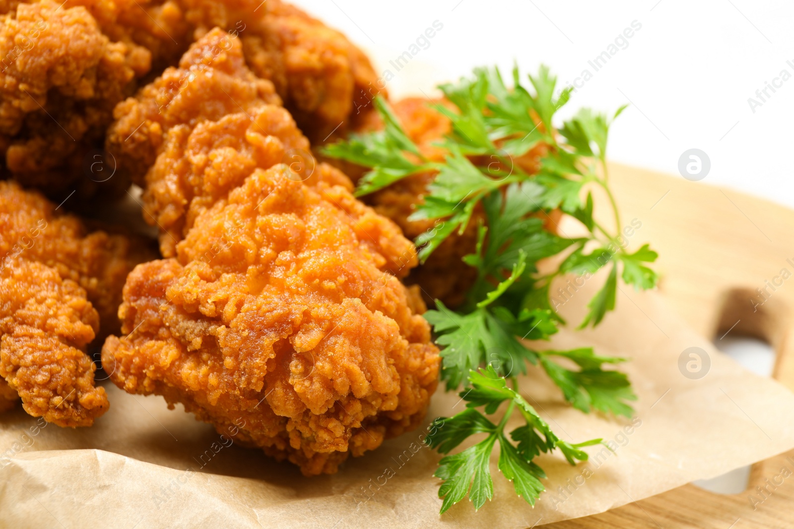 Photo of Tasty deep fried chicken pieces served on table, closeup