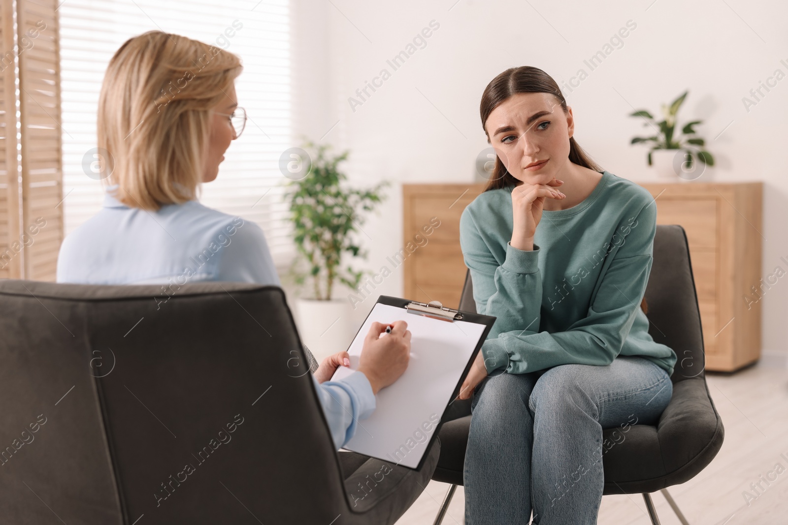 Photo of Professional psychotherapist working with patient in office