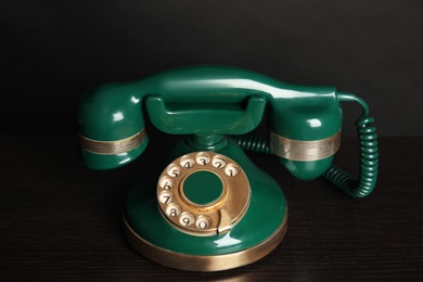 Green vintage corded phone on black table