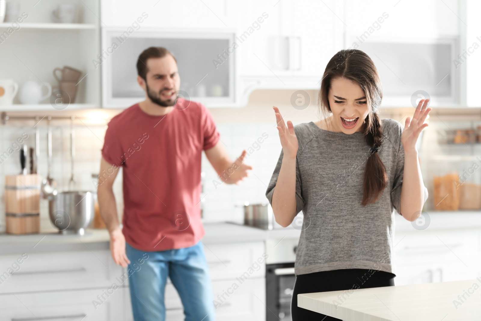 Photo of Young couple having argument in kitchen